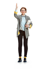 Image showing Full length portrait of a happy smiling female student holding books isolated on white background