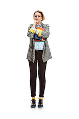 Image showing Full length portrait of a unhappy female student holding books isolated on white background