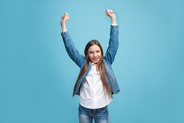 Image showing Happy success teen girl celebrating being a winner. Dynamic energetic image of female model