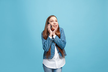 Image showing Beautiful teen girl looking suprised isolated on blue