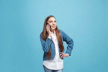 Image showing Beautiful teen girl looking suprised isolated on blue