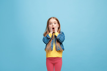 Image showing Beautiful teen girl looking suprised isolated on blue