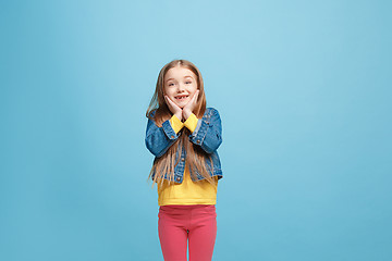 Image showing Beautiful teen girl looking suprised isolated on blue