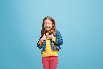 Image showing The happy teen girl standing and smiling against pink background.