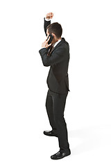 Image showing Thee profile portrait of a businessman with very serious face. Confident professional with mobile phone