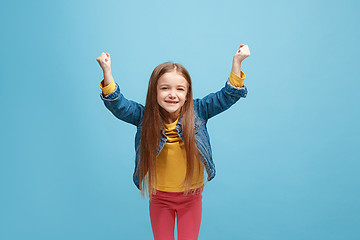 Image showing Happy success teen girl celebrating being a winner. Dynamic energetic image of female model