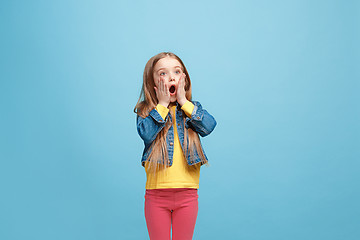 Image showing Beautiful teen girl looking suprised isolated on blue