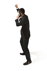 Image showing Thee profile portrait of a businessman with very serious face. Confident professional with mobile phone