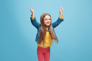 Image showing Happy success teen girl celebrating being a winner. Dynamic energetic image of female model