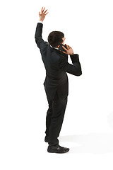 Image showing Back view portrait of a businessman. Confident professional with mobile phone