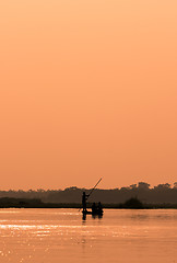 Image showing Men in a boat on a river silhouette