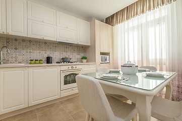 Image showing Modern beige colored kitchen and dining room