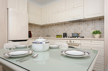 Image showing Modern beige colored kitchen and dining room