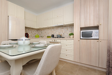 Image showing Modern beige colored kitchen and dining room