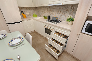 Image showing Modern beige colored kitchen and dining room