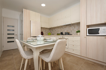 Image showing Modern beige colored kitchen and dining room