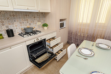 Image showing Modern beige colored kitchen and dining room