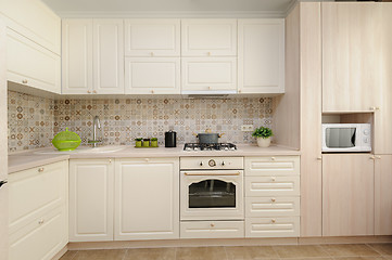 Image showing Modern beige colored kitchen and dining room