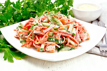 Image showing Salad of sausage and spicy carrots with mayonnaise on light wood