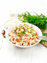 Image showing Salad of surimi and eggs with mayonnaise on light table