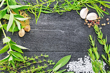 Image showing Frame from herbs and garlic on black board