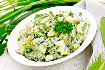 Image showing Salad with potatoes and sorrel on wooden board