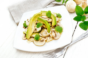 Image showing Salad of avocado and champignons on light board