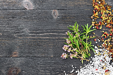 Image showing Thyme leaves and flowers with spices on black board