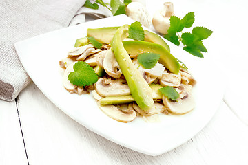 Image showing Salad of avocado and champignons on board