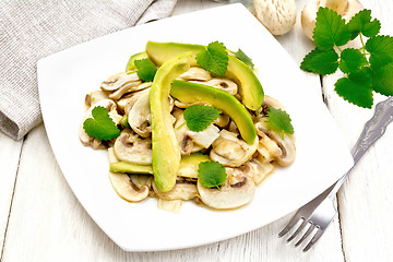 Image showing Salad of avocado and champignons on wooden table
