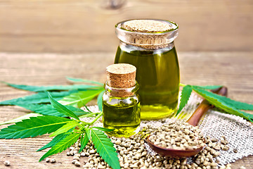 Image showing Oil hemp in two jars on board