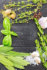 Image showing Frame from herbs and spices on black wooden board