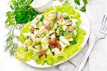 Image showing Salad of salmon and avocado on wooden table