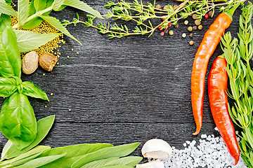 Image showing Frame from herbs and pepper on black wooden board