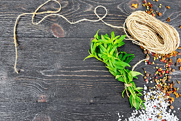 Image showing Savory leaves with twine on black board