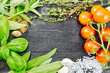 Image showing Frame from herbs and tomatoes on black board