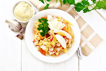 Image showing Salad of surimi and tomatoes with eggs on board top