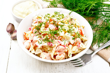 Image showing Salad of surimi and eggs with mayonnaise on light board