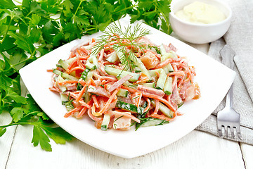 Image showing Salad of sausage and spicy carrots with mayonnaise on white boar