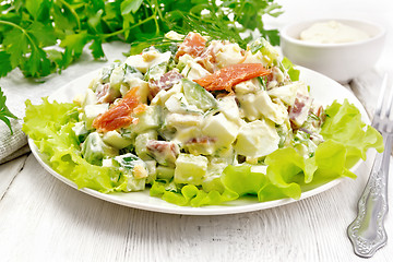 Image showing Salad of salmon and avocado with mayonnaise on light wooden boar