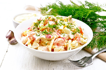 Image showing Salad of surimi and eggs with mayonnaise on wooden board