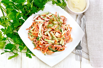 Image showing Salad of sausage and spicy carrots with mayonnaise on table top