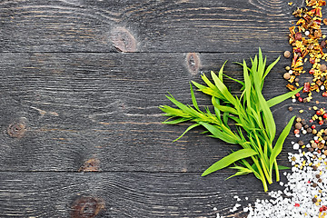 Image showing Tarragon leaves with spices on black board