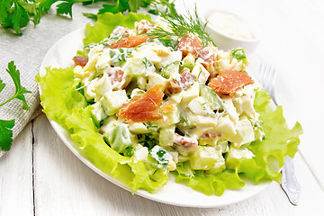 Image showing Salad of salmon and avocado with mayonnaise on white wooden boar