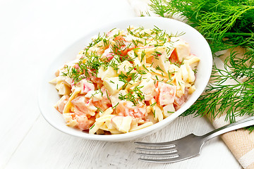 Image showing Salad of surimi and eggs with mayonnaise on board