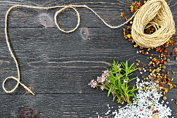 Image showing Thyme leaves and flowers with twine on black wooden board