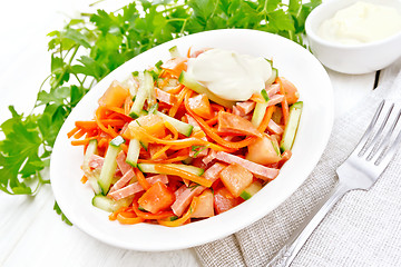 Image showing Salad of sausage and spicy carrots on light wooden board