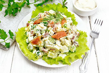 Image showing Salad of salmon and avocado with mayonnaise on wooden board