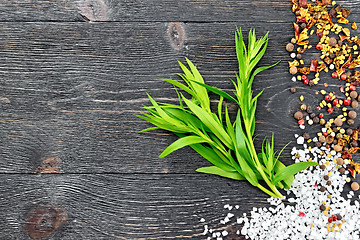 Image showing Tarragon leaves with spices on black wooden board