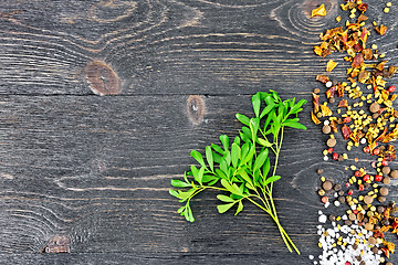 Image showing Rue leaves with spices on black board